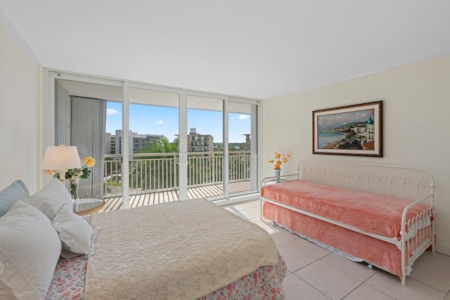 bedroom featuring access to exterior, floor to ceiling windows, and light tile patterned flooring