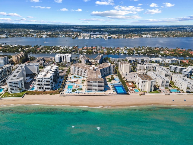 aerial view featuring a beach view, a water view, and a city view