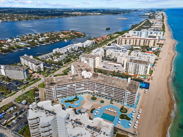 birds eye view of property with a view of the beach, a water view, and a view of city