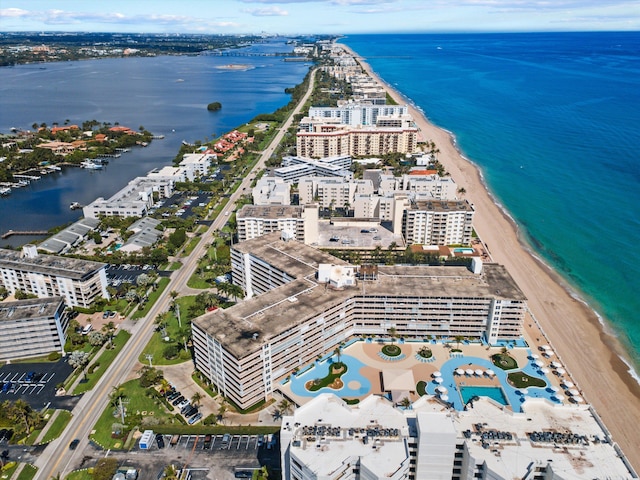 birds eye view of property with a water view, a city view, and a view of the beach