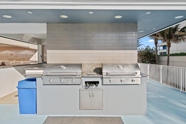 view of patio / terrace featuring fence, grilling area, and exterior kitchen