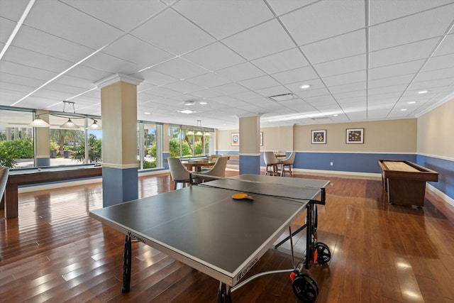 rec room featuring wood-type flooring, baseboards, and a drop ceiling