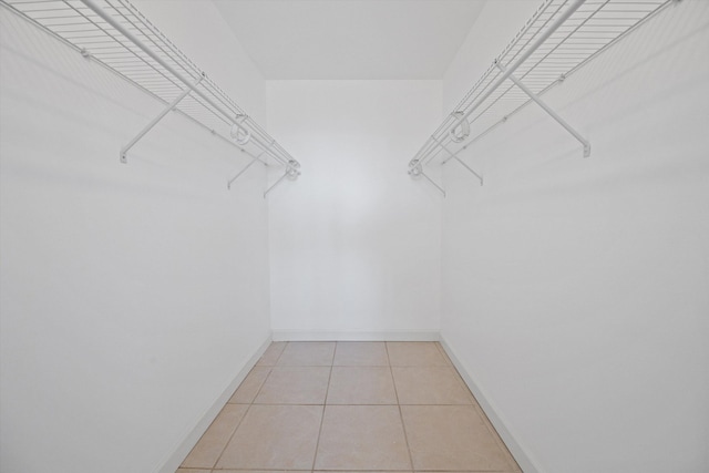 spacious closet with light tile patterned floors