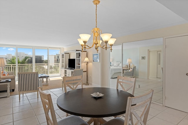 dining area with light tile patterned floors, baseboards, ornamental molding, and a chandelier