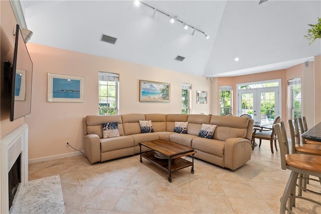 living room featuring high vaulted ceiling, baseboards, visible vents, and french doors