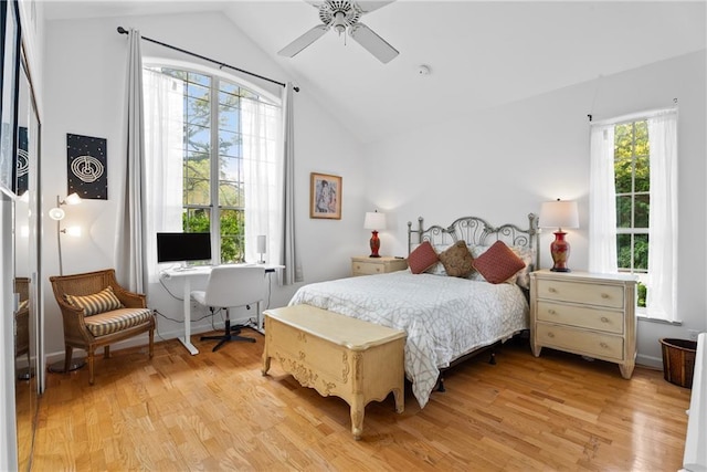 bedroom featuring lofted ceiling, light wood finished floors, and ceiling fan