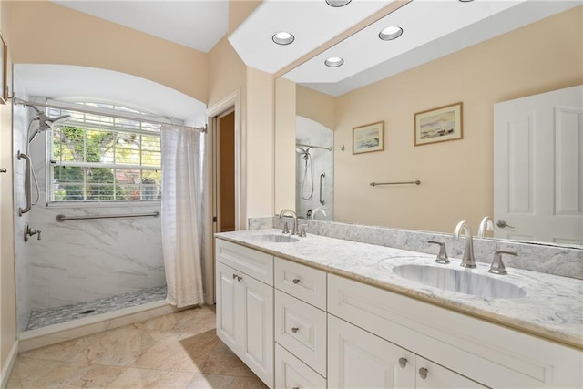 bathroom featuring double vanity, a shower with shower curtain, and a sink