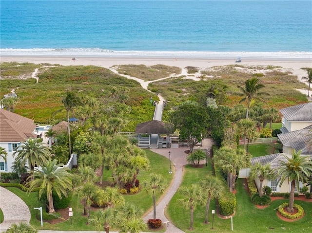 birds eye view of property featuring a water view and a beach view