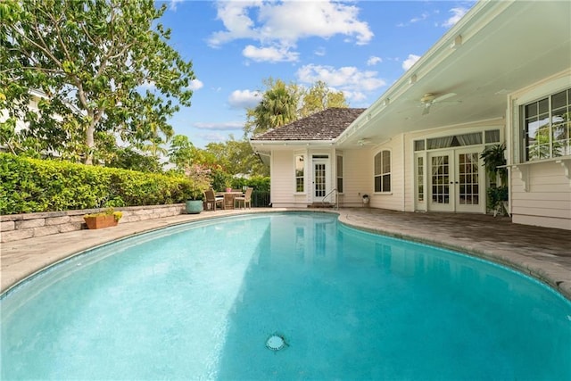 pool with french doors and a patio area