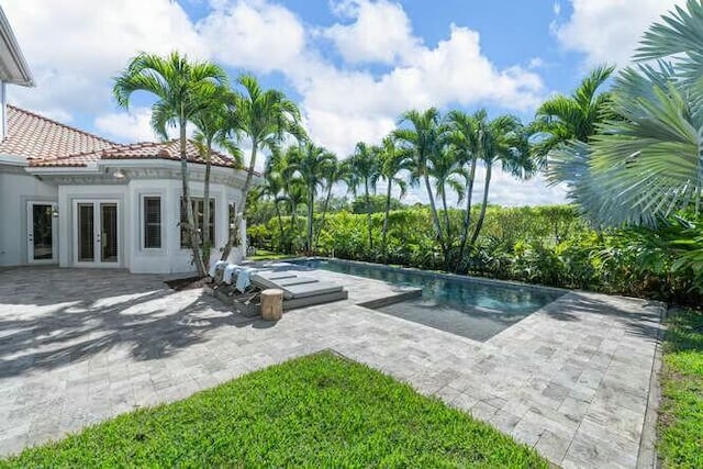 pool featuring french doors and a patio area