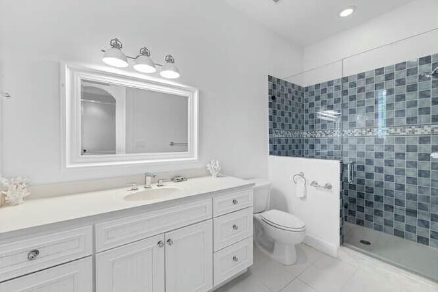 bathroom featuring a stall shower, vanity, and toilet