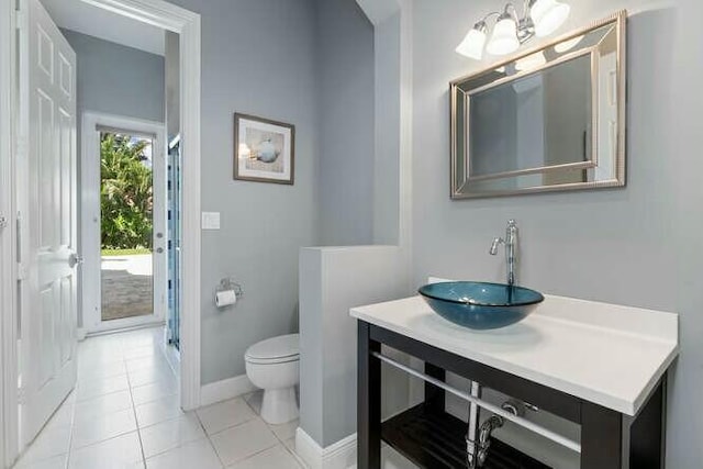 full bathroom with baseboards, toilet, tile patterned floors, an enclosed shower, and vanity