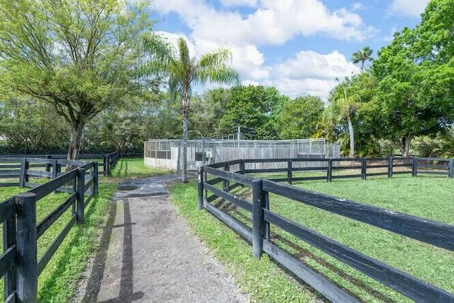 view of gate featuring a yard and fence