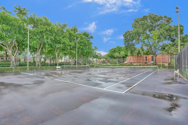 view of tennis court with fence