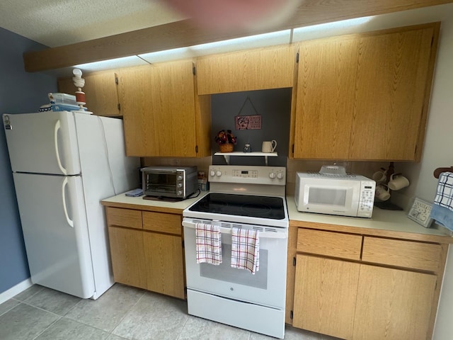 kitchen featuring white appliances, light countertops, and a toaster