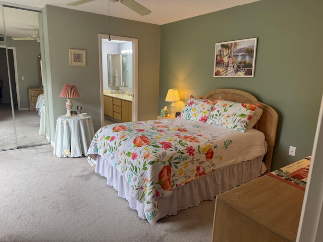 bedroom featuring a closet, carpet flooring, ceiling fan, and ensuite bathroom