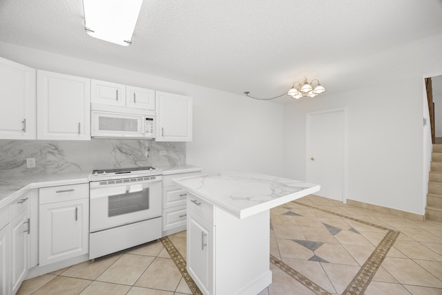 kitchen featuring white appliances, tasteful backsplash, light tile patterned floors, a textured ceiling, and white cabinetry