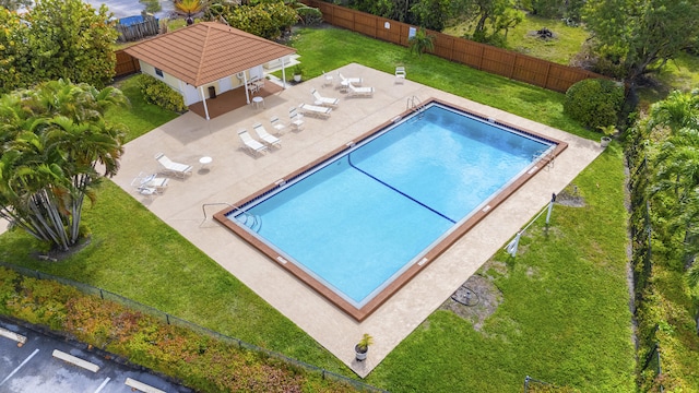 community pool with a yard, a fenced backyard, a patio, and a gazebo