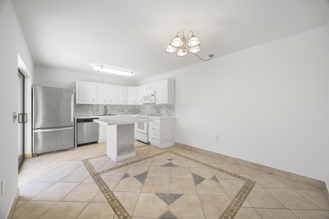 kitchen with appliances with stainless steel finishes, baseboards, and tasteful backsplash