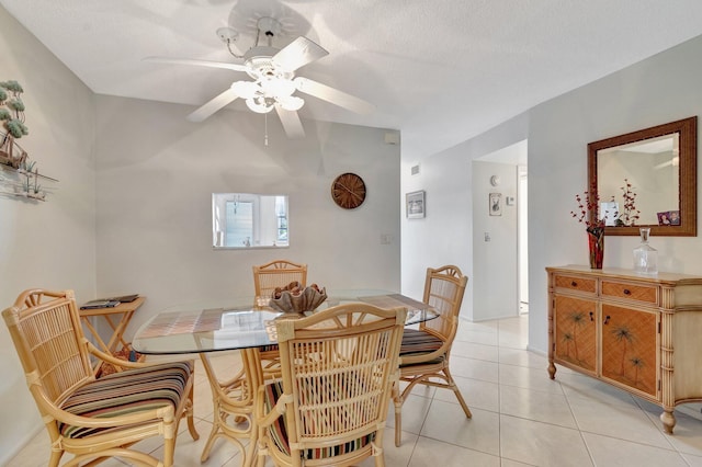 dining area featuring visible vents, ceiling fan, a textured ceiling, and light tile patterned floors