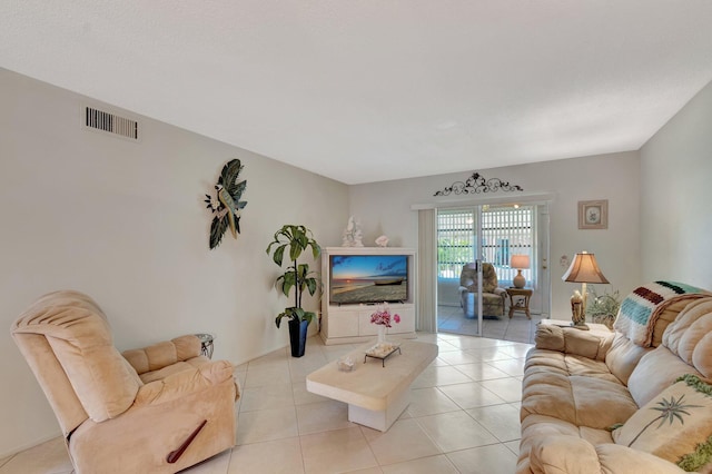 living room with light tile patterned floors and visible vents