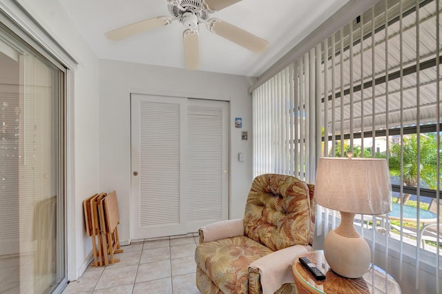 sitting room with light tile patterned floors and a ceiling fan