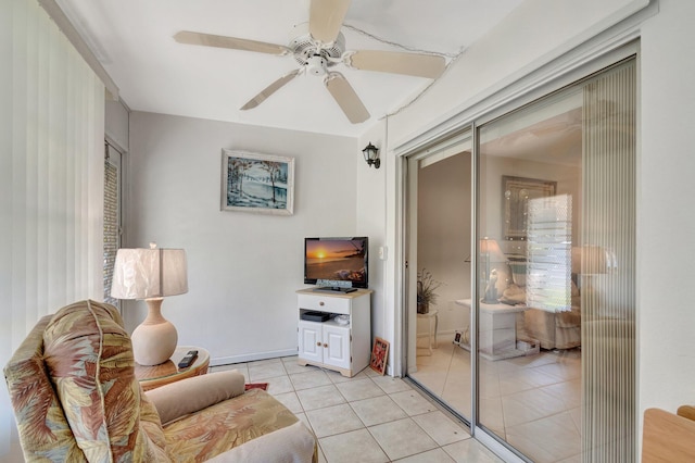 living room featuring ceiling fan and light tile patterned floors