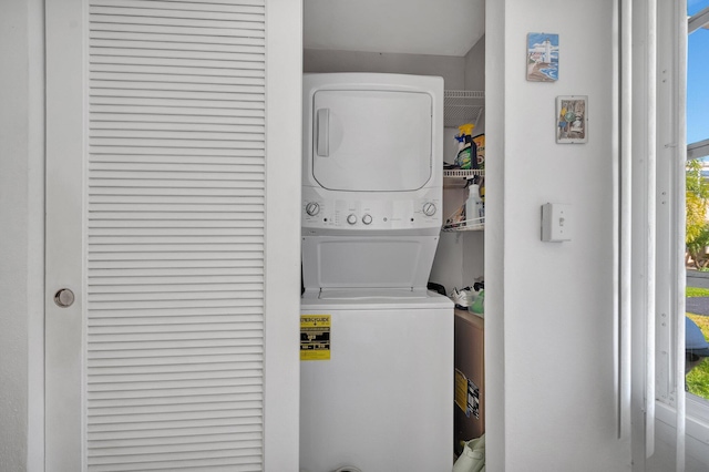 laundry area featuring stacked washing maching and dryer and laundry area