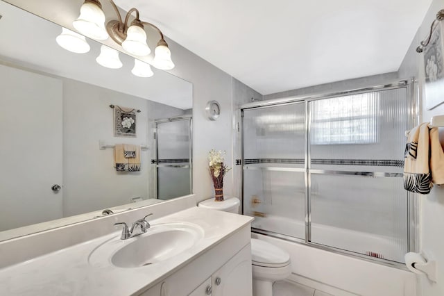 full bath featuring toilet, enclosed tub / shower combo, a chandelier, and vanity