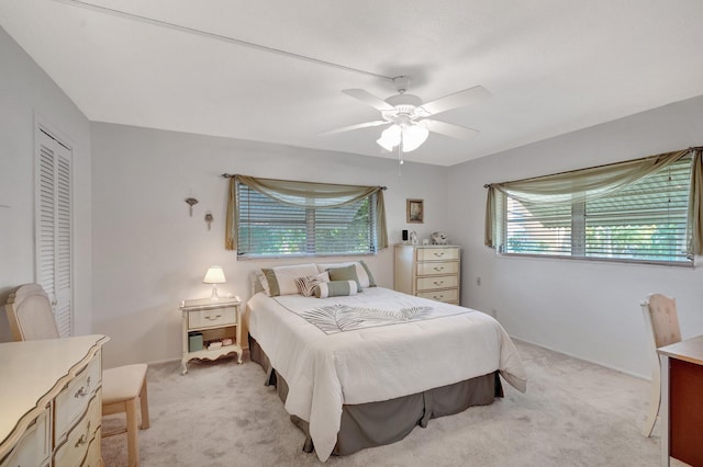 bedroom featuring light carpet, a closet, and a ceiling fan