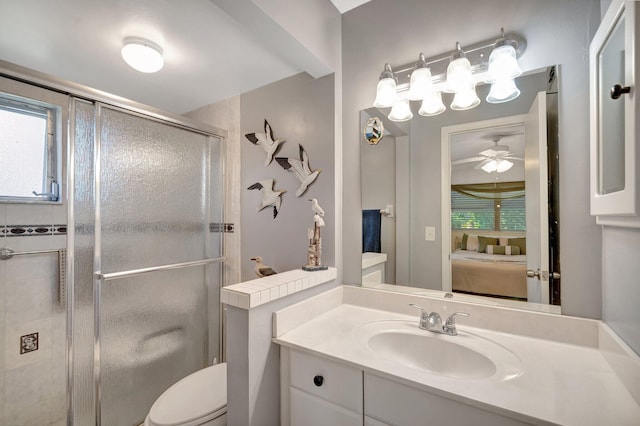 bathroom featuring toilet, ceiling fan, ensuite bathroom, vanity, and a shower stall