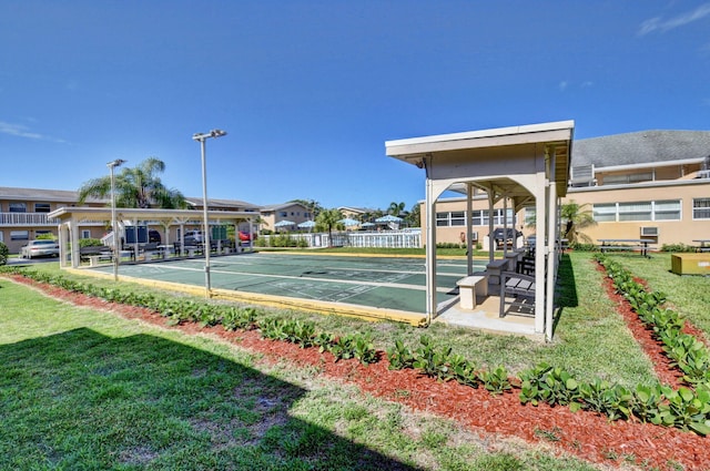 exterior space with shuffleboard and a yard