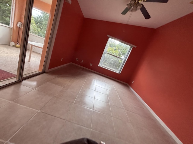 bonus room featuring light tile patterned floors, plenty of natural light, and baseboards