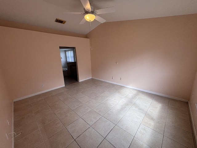 unfurnished room featuring lofted ceiling, baseboards, visible vents, and a ceiling fan