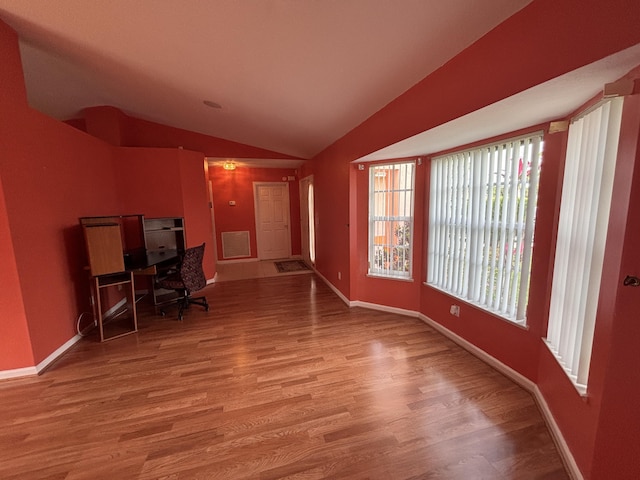 home office with baseboards, vaulted ceiling, and wood finished floors