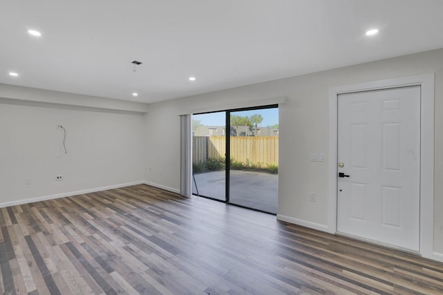 unfurnished room featuring recessed lighting, baseboards, and wood finished floors