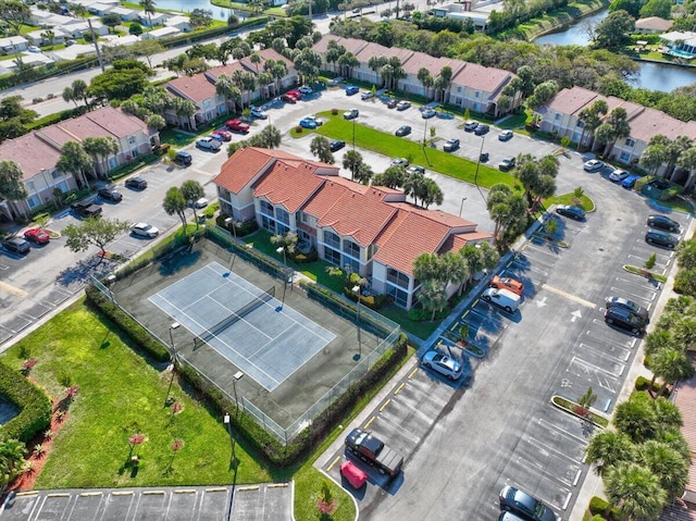 birds eye view of property with a water view and a residential view