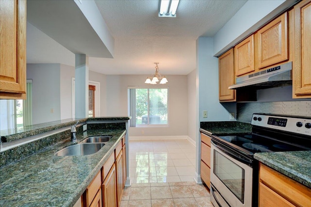 kitchen featuring dark stone counters, under cabinet range hood, a sink, and stainless steel range with electric cooktop