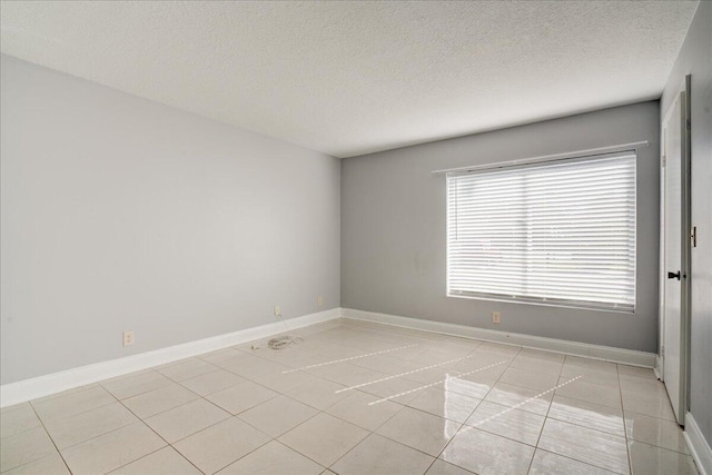 unfurnished room with baseboards and light tile patterned floors