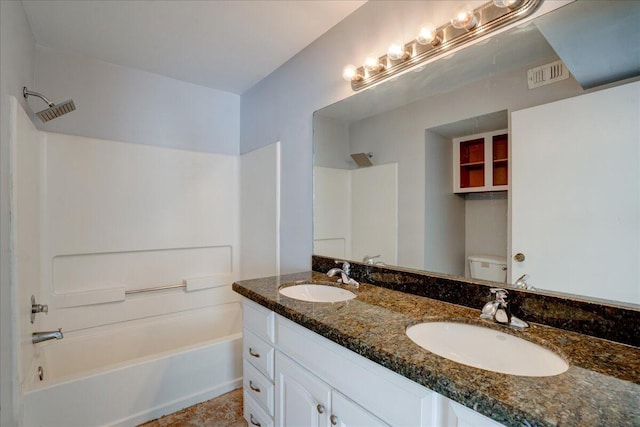 full bath with visible vents, double vanity, a sink, and toilet