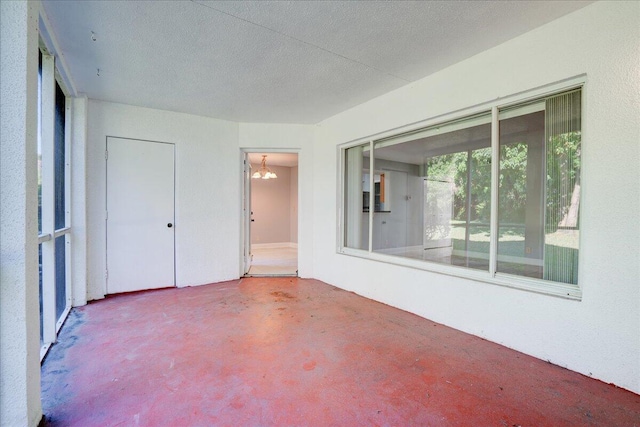 interior space featuring concrete floors and a textured ceiling