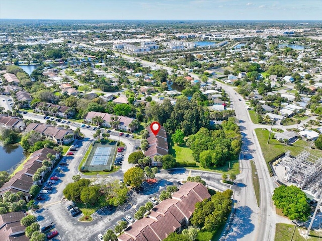 drone / aerial view featuring a water view and a residential view