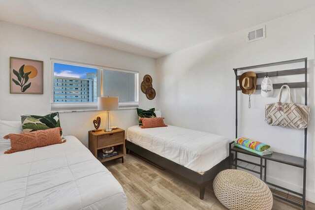 bedroom featuring baseboards and wood finished floors