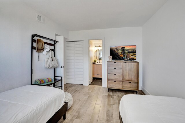 bedroom featuring visible vents and wood finished floors