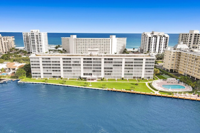 birds eye view of property featuring a water view and a city view