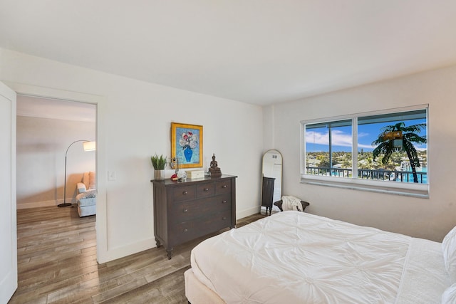 bedroom featuring wood finished floors and baseboards