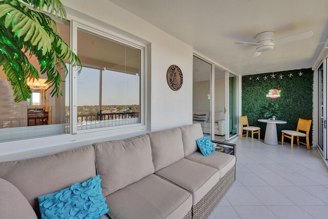 balcony with a water view and ceiling fan