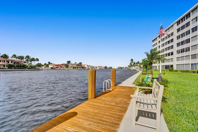 dock area with a water view and a yard