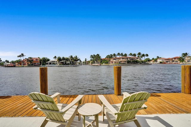 view of dock with a water view and a residential view