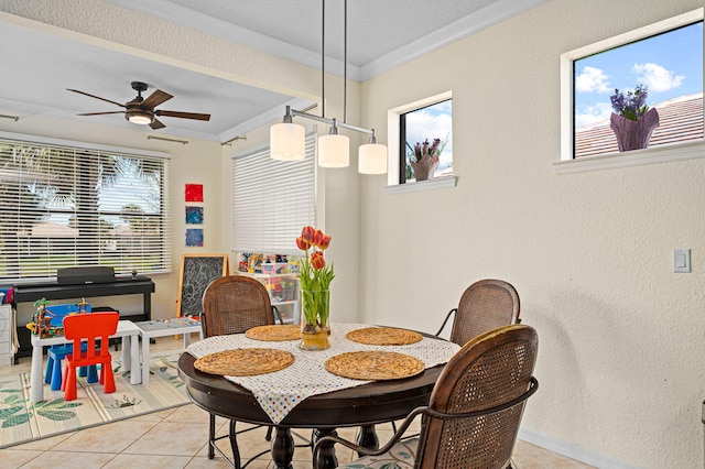 dining room featuring crown molding, a textured wall, ceiling fan, tile patterned floors, and baseboards